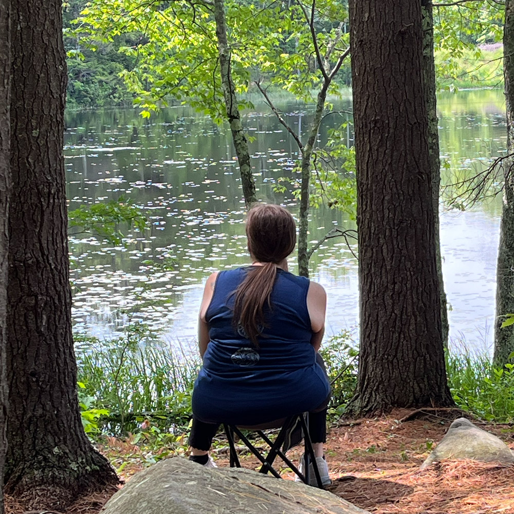 person sitting by water
